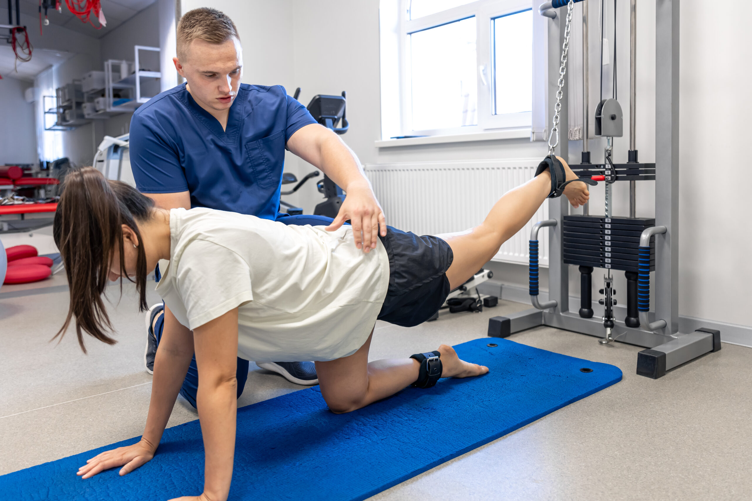 Woman does exercise to stretch muscles, patient performing a strength training exercise assisted.